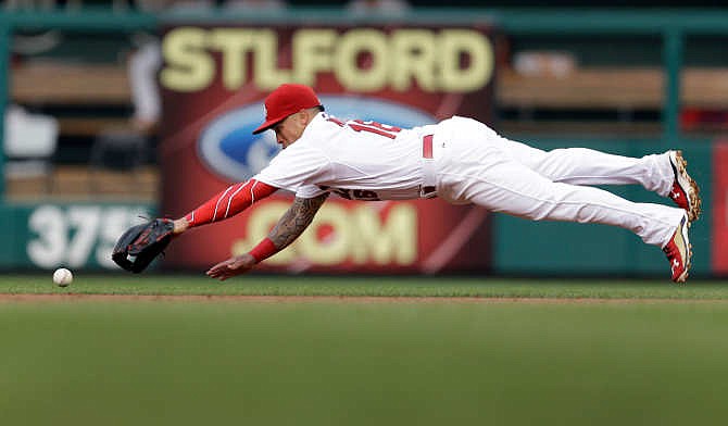 St. Louis Cardinals second baseman Kolten Wong can't reach a single hit by San Diego Padres' Will Venable during the second inning of a baseball game Friday, July 3, 2015, in St. Louis. 