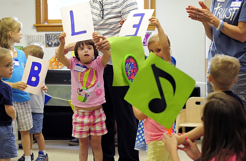Anna Fichter, center, holds up her "L' as she and other letter holders get set to help lead a singalong of "The B-I-B-L-E" during VBS Special Edition at the Special Learning Center on Wednesday. The vacation bible school was designed to serve children with special needs and was hosted by volunteers from St. John's Lutheran Church in Schubert.
