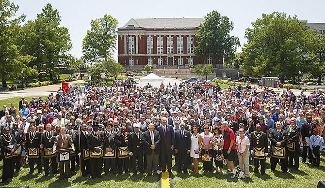 Members of the audience pose in Jefferson City for a photo to be included in the 2015 time capsule, to be opened in 2115, Friday during the Missouri State Capitol Cornerstone and Time Capsule Dedication ceremony on the south lawn of the Capitol.