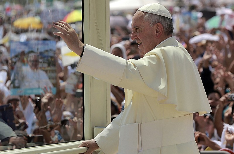 Pope Francis waves as he rides aboard the Popemobile after arriving in Samanes Park where he will celebrate Mass, in Guayaquil, Ecuador.