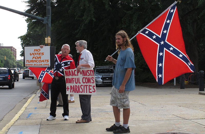 William Cheek, left, Nelson Waller, center, and Jim Collins, right, protest proposals to remove the Confederate flag from the grounds of the South Carolina Statehouse on Monday in Columbia, S.C. The General Assembly returns Monday to discuss Gov. Nikki Haley's budget vetoes and what to do with the rebel flag that has flown over some part of the Statehouse for more than 50 years. 