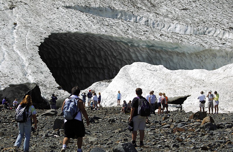 Visitors examine the Big Four Ice Caves in the Mt. Baker-Snoqualmie National Forest near Granite Falls, Washington, in 2010. The Snohomish County sheriff's office says rescuers responded to a report of a partial collapse of the ice caves Monday.