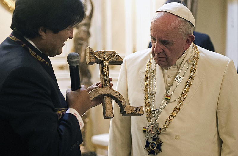 Bolivian President Evo Morales presents Pope Francis with a crucifix carved into a wooden hammer and sickle.