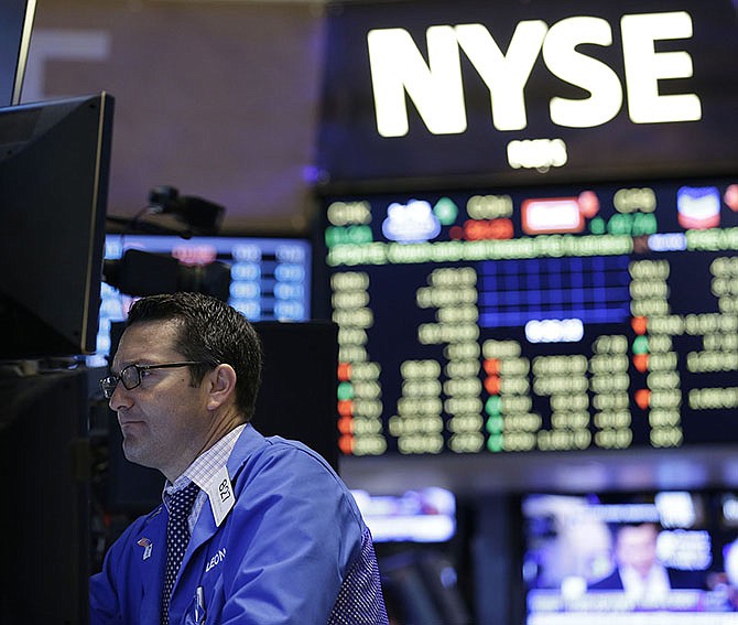 Traders work on the floor at the New York Stock Exchange in New York, Wednesday. Hong Kong's main stock index plummeted as much as 8.5 percent on Wednesday as a sell-off in mainland Chinese shares accelerated despite new measures to support the market; U.S. stocks were poised to open lower.