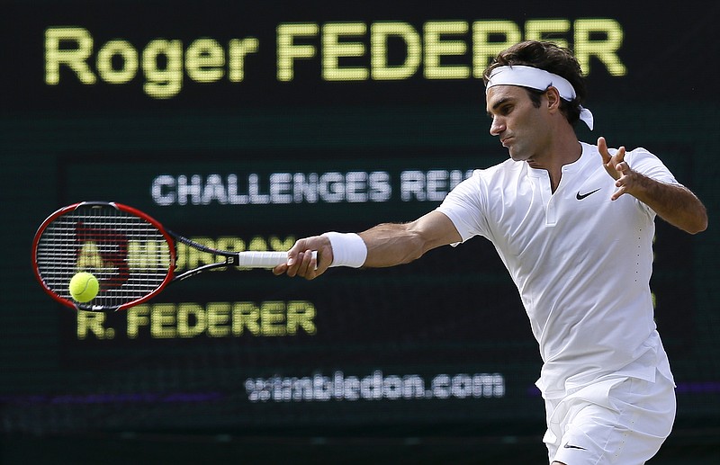Roger Federer returns a shot to Andy Murray during their men's singles semifinal match Friday at Wimbledon.