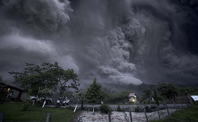 Clouds of ash fill the sky after an eruption by the Colima volcano, known as the Volcano of Fire, near the town of Comala, Mexico, Friday, July 10, 2015. The volcano spewed ash more than 4 miles (7 kilometers) into the air and released some quantity of lava. People were advised to recognize a 3-mile (5-kilometer) perimeter around the peak.