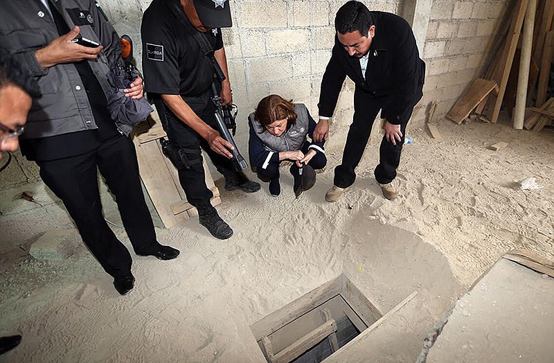 Authorities inspect the exit of the tunnel they claim was used by drug lord Joaquin "El Chapo" Guzman to break out of the Altiplano maximum security prison.
