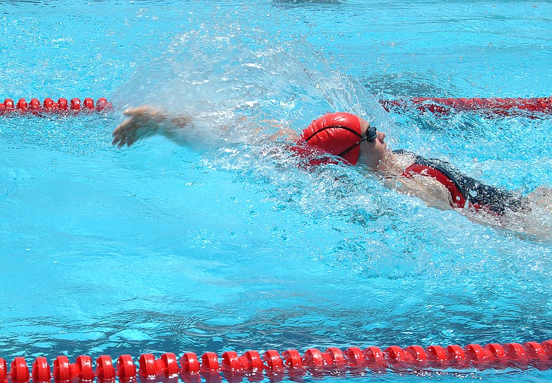 Sarah McCord competes in a back stroke race at the Mid-Mo Swim Conference Championship Saturday, July 11.