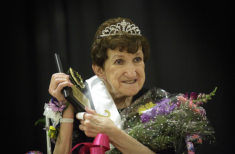 Villa Marie resident Wanda Campbell holds up her winner's plaque after being named the 2015 Ms. Nursing Home Pageant Queen for Missouri Health Care Association Region 7. 