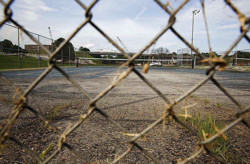 Court surfaces are worn and grass grows through cracks at the Lincoln University tennis courts on the corner of Dunklin and Lafayette Streets. 
