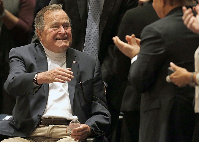 Former President George H.W. Bush acknowledges the crowd in 2014 at an event in College Station, Texas. Bush, 91, fell at home Wednesday in Kennebunkport, Maine, and broken a bone in his neck. 
