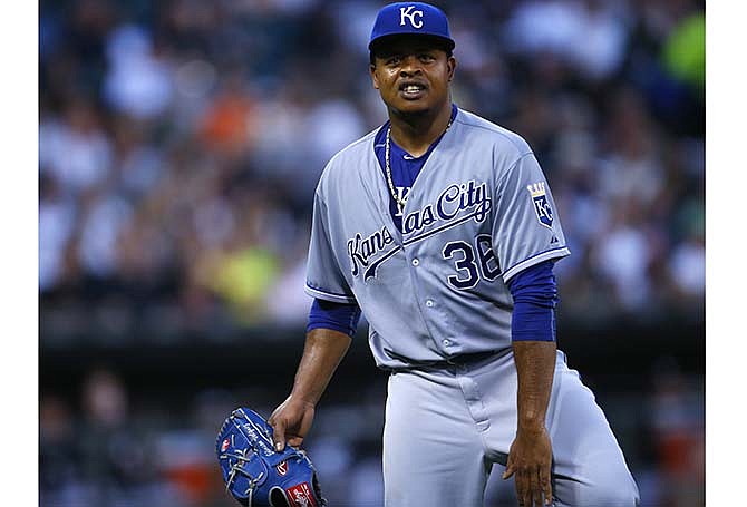 Kansas City Royals starting pitcher Edinson Volquez reacts after being hit by a ball during the third inning of a baseball game against the Chicago White Sox in Chicago, Friday, July 17, 2015.