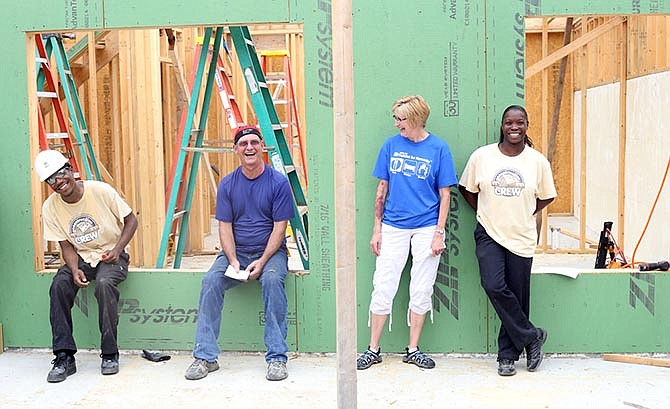 Byron Nickerson, left, and Celia Hinton, far right, stand with volunteers and members of River City Habitat for Humanity on Saturday.