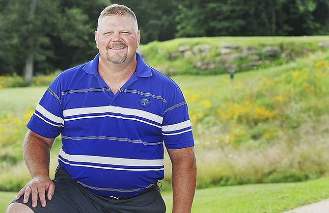 Kevin Wieberg,
Oak
Hills golf
course
grounds
superintendent,
poses
for a photograph
in
front of the
third hole at
the back of
the course.