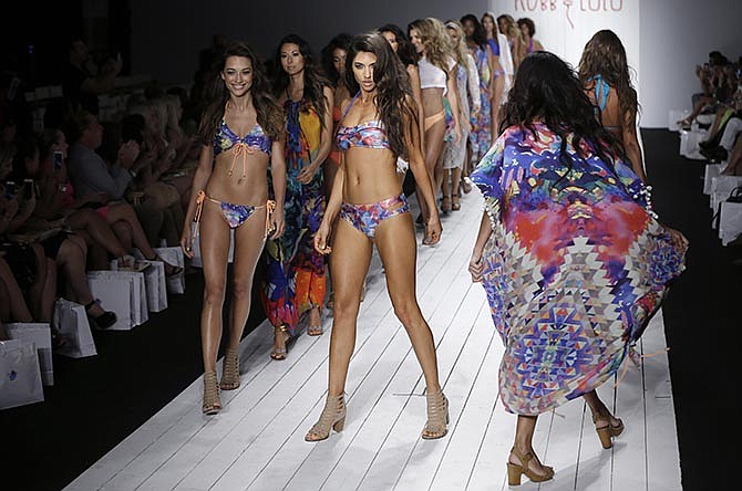 Models walk down the runway during the Robb & Lulu swimwear show as part of Funkshion Fashion Week Swim, Friday, July 17, 2015, in Coral Gables, Fla.