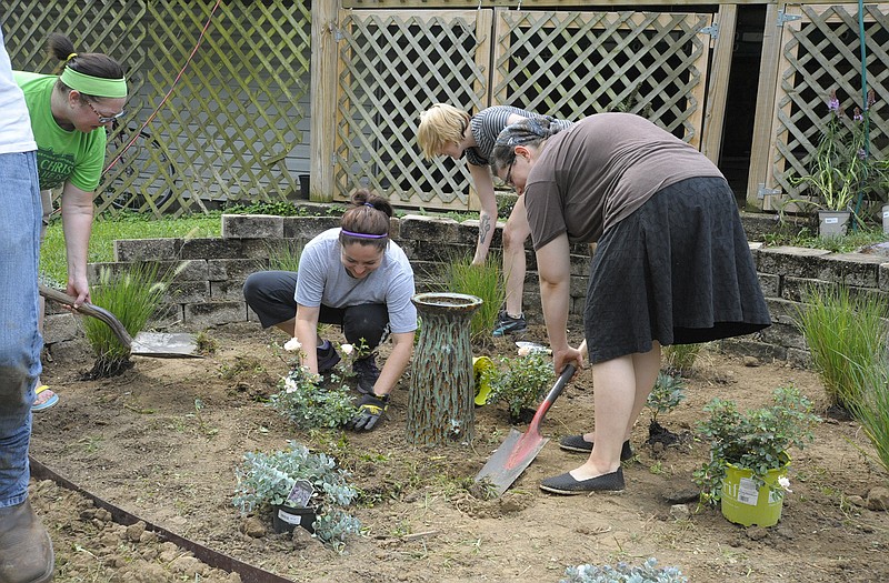 Members of the Freshwater Church helped with some landscaping at the Healing House, 1418 W. Main St., Sunday morning as its annual Labor for Your Neighbor activity.
