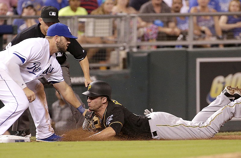 Royals third baseman Mike Moustakas tags out Travis Ishikawa of the Pirates during the eighth inning of Monday night's game at Kauffman Stadium.