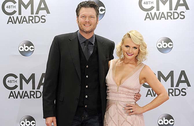 In this Nov. 5, 2014 file photo, Blake Shelton, left, and Miranda Lambert arrive at the 48th annual CMA Awards in Nashville, Tenn. Shelton and Lambert announced their divorce after four years of marriage.A statement from Shelton's spokesman provided a statement from both of them on Monday, July 20, 2015. (Photo by Evan Agostini/Invision/AP, File)