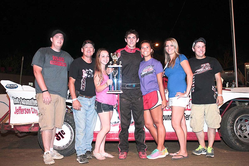 Third generation driver Cole Henson of Russellville claims his first feature victory at Double-X Speedway. Henson is joined by family and friends as well as Double-X Speedway trophy girls Kelsey Brauner and Courtney Pettigrew.