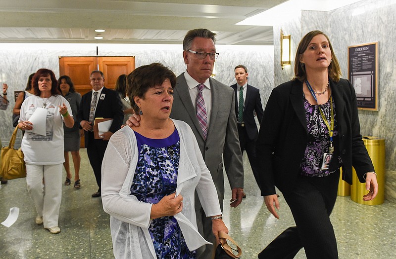 Liz Sullivan and Jim Steinle, parents of Kathryn Steinle, killed on a San Francisco Pier by a man previously deported several times, walk out after a Senate Judiciary hearing in Washington. The family told Congress they support changing the laws that allowed her alleged killer to remain in the United States despite being deported several times. 