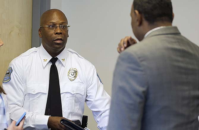 Interim Ferguson police chief Andre Anderson, left, speaks with interim city manager, Ed Beasley, following a news conference introducing Anderson as the new police chief, Wednesday, July 22, 2015, in Ferguson, Mo. Anderson becomes the second interim chief since Police Chief Thomas Jackson stepped down in March. 