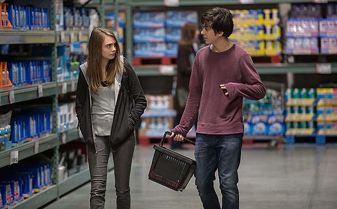 This photo provided by Twentieth Century Fox shows Cara Delevingne, left, as Margo, and Nat Wolff as Quentin, in a scene from the film, "Paper Towns."