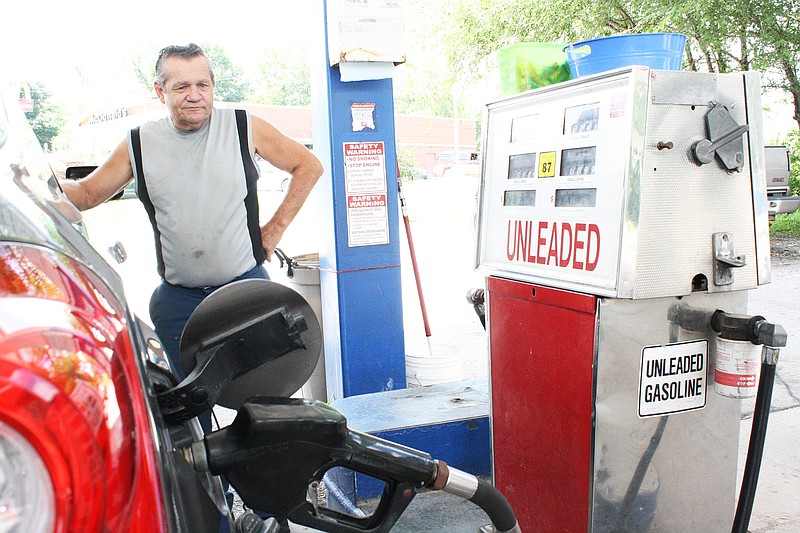 Gas Plus Pump Attendant Dave Wormack waits for the pump to fill up a customer's vehicle Wednesday. It was the last day doors were open at the Gas Plus in Fulton.