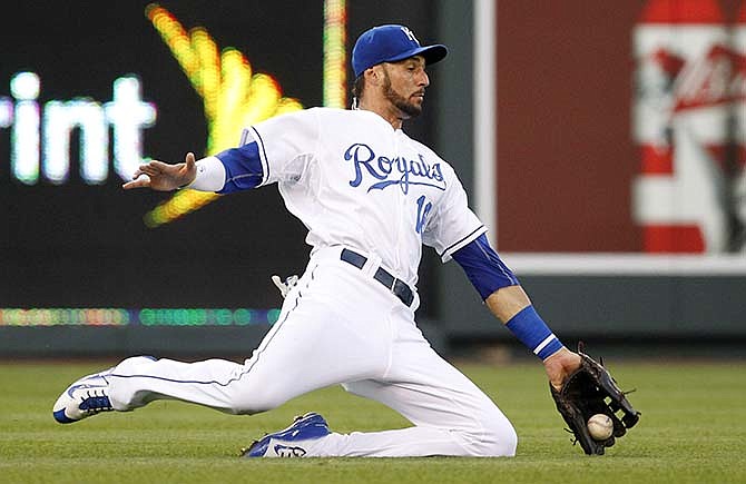 Kansas City Royals left fielder Paulo Orlando is unable to catch a short fly ball hit by Houston Astros designated hitter Evan Gattis in the fourth inning of a baseball game in Kansas City, Mo., Friday, July 24, 2015. Gattis singled on the play.