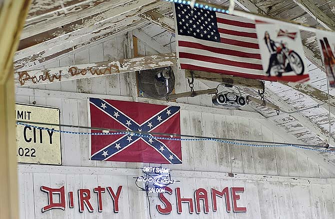 A Confederate flag hangs above the stage in the Dirty Shame Saloon at the Platte County Fairgrounds in northwest Missouri on Wednesday, July 22, 2015. The fair board has decided to take down the Confederate flag during this weekend's fair. The board's president says the flag was put away Wednesday until after the fair's annual stockholder's meeting, when a final decision on its future will be made. (Jill Toyoshiba/The Kansas City Star via AP)