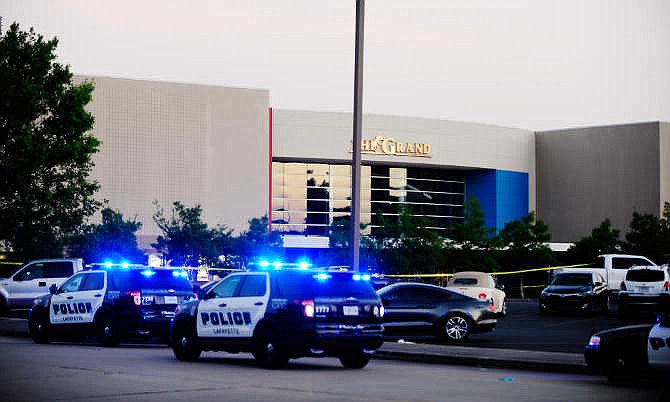 Law enforcement and other emergency personnel respond to the scene of a deadly shooting at the Grand Theatre on Thursday, July 23, 2015, in Lafayette, La. (Leslie Westbrook/The Advocate via AP)