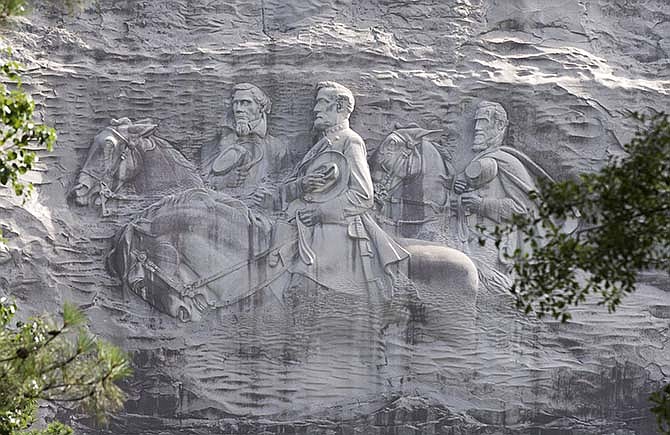 A Tuesday, June 23, 2015 file photo shows a carving depicting confederates Stonewall Jackson, Robert E. Lee and Jefferson Davis, in Stone Mountain, Ga. The "Confederate Memorial Carving" in a state park outside of Atlanta is once again stirring controversy, as Georgia officials try to decide what, if anything, to do about a huge sculpture that memorializes three of the South's Civil War heroes but causes offense to blacks and others.