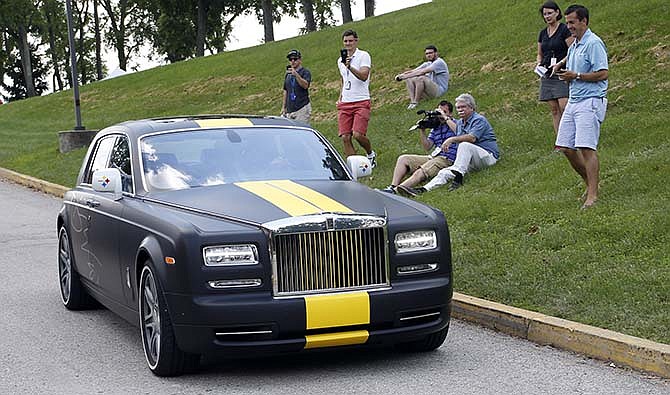 Pittsburgh Steelers wide receiver Antonio Brown is driven in his custom Steelers-themed Rolls Royce as he arrives for NFL football training camp at the team's training facility in Latrobe, Pa., Saturday, July 25, 2015.