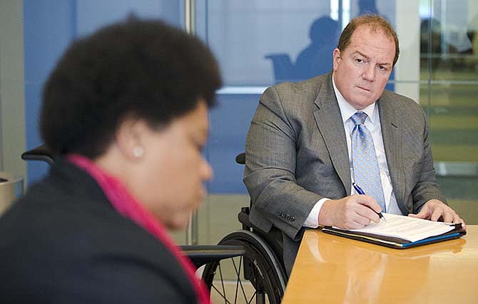 Fred Maahs, a Comcast executive, takes part in a meeting at the company's headquarters in Philadelphia on Monday, July 13, 2015. In 1980, on the last day of summer vacation off the Delaware coast, the 18-year-old took a dive from his family's boat into an unseen sandbar barely a foot below the surface, sustaining injuries that paralyzed him from the chest down.