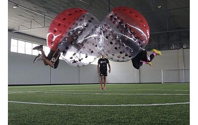 Knockerball, a new entertainment
option available in Jefferson City, allows
players to participate in a high-contact
game cushioned by the inflatable plastic
bubble surrounding them.