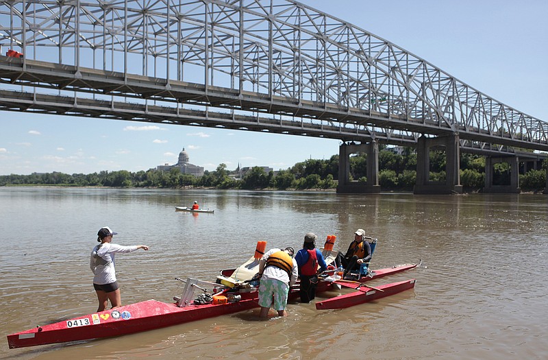 Kelly Kasten helps get the team "The Third Wheel" back on the water and ready to continue the MR340 race last summer at Noren's river access in North Jefferson City. 