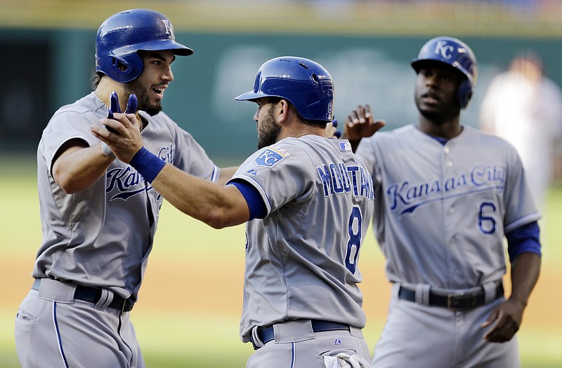 Eric Hosmer (left) is congratulated by Royals teammate Mike Moustakas after Hosmer hit a three-run home run in the first inning of Monday night's game against the Indians in Cleveland. Moustakas and Lorenzo Cain (right) scored on the play.