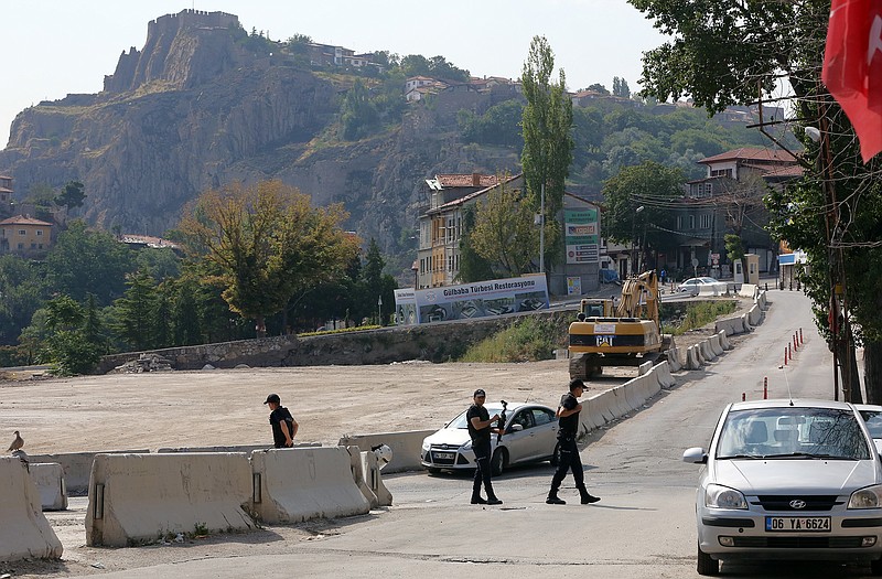Police officers patrol as Turkish police raid homes in Haci Bayram neighborhood on Monday in the capital Ankara, Turkey.