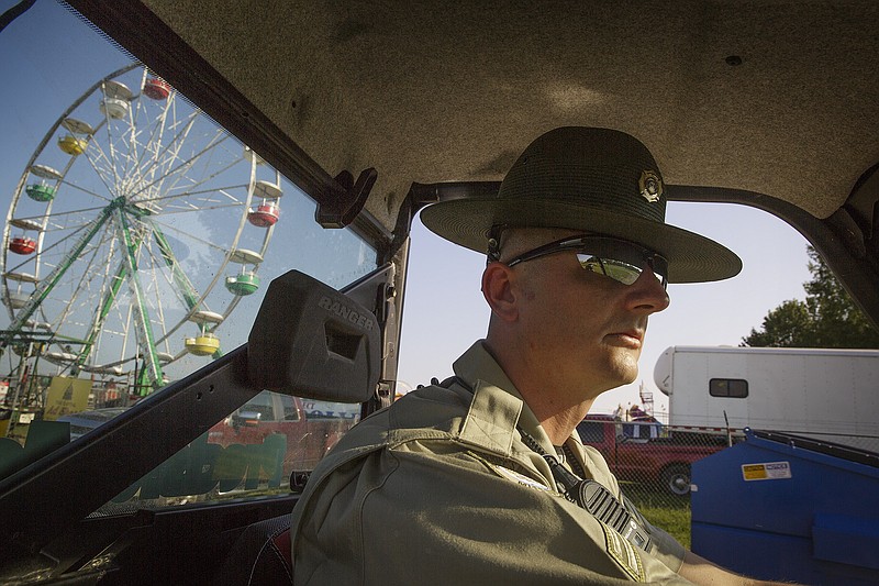 Cpl. Justin Rollins makes the rounds Tuesday evening at the Jaycees Fairgrounds during his shift with the Cole County Sheriff's Department.