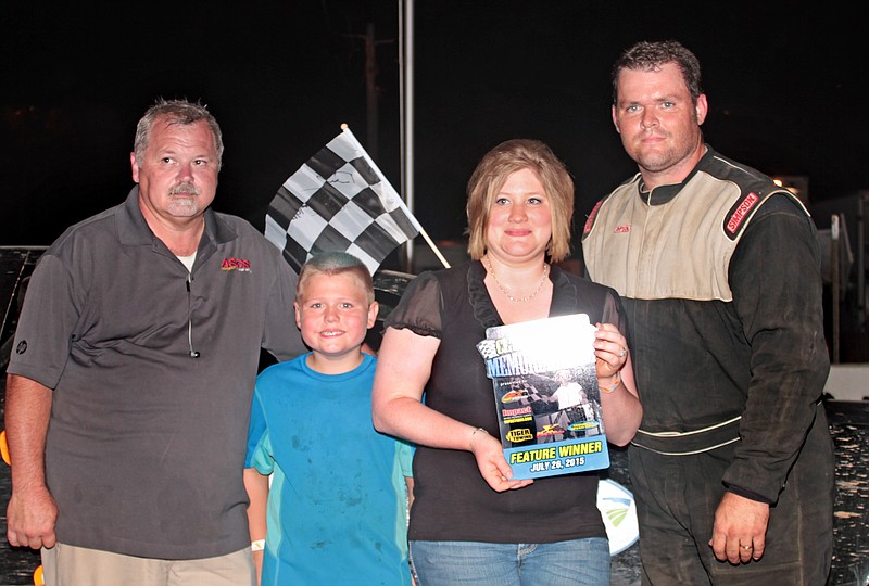 Brandon Dunham, California, was victorious in the super stock division of the 13th annual "Clyde Wood Memorial" Sunday night at Double-X Speedway. Presenting the custom made trophy is Felicia Wood Braun of Stover and her father Roy Wood, promoter of the event. Roy Wood, of California, is the son of the late Clyde Wood and Mary Kay Wood.