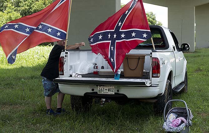 A man stands next to a truck during a rally in support of the Confederate battle flag, Sunday, July 19, 2015, in Loudon, Tenn. 