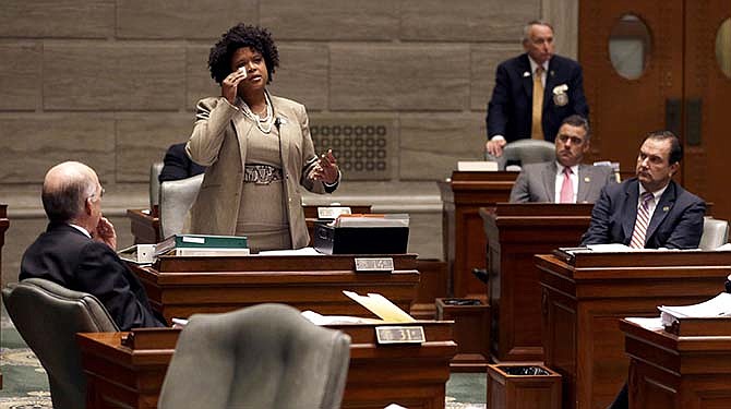 In this Sept. 10, 2014 file photo, Missouri state Sen. Maria Chappelle-Nadal wipes her eye as she speaks on the Senate floor in Jefferson City, Mo. Chappelle-Nadal, who was among the those tear gassed by police while protesting Michael Brown's shooting with her constituents in Ferguson, Mo., said as a state, Missouri has not done much. Lawmakers filed about 65 bills stemming from the events in Ferguson passing just one, a measure limiting municipal court fines and traffic tickets.