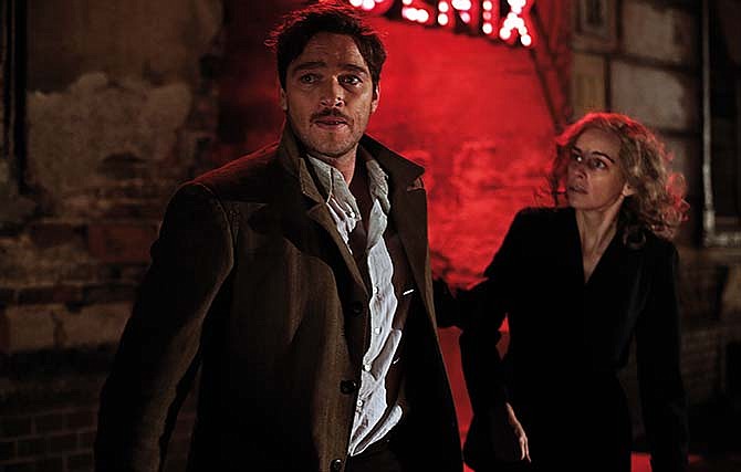 In this image released by IFC Films, Ronald Zehrfeld, left, and Nina Hoss appear in a scene from "Phoenix." 