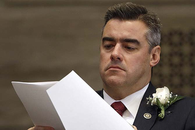  In this Jan. 9, 2013 file photo, Missouri Senate President Pro Tem Tom Dempsey, R-St. Charles, looks over papers on the first day on Missouri's 2013 legislative session in Jefferson City, Mo. Dempsey says Friday, July 31, 2015 he is resigning from office to return to the private sector and spend more time with his family. His resignation will take effect Aug. 7.