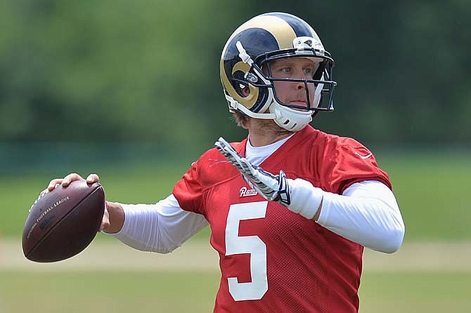 In this June 11, 2015, file photo, St. Louis Rams quarterback Nick Foles throws a pass during an NFL football organized team activity in St. Louis. 
