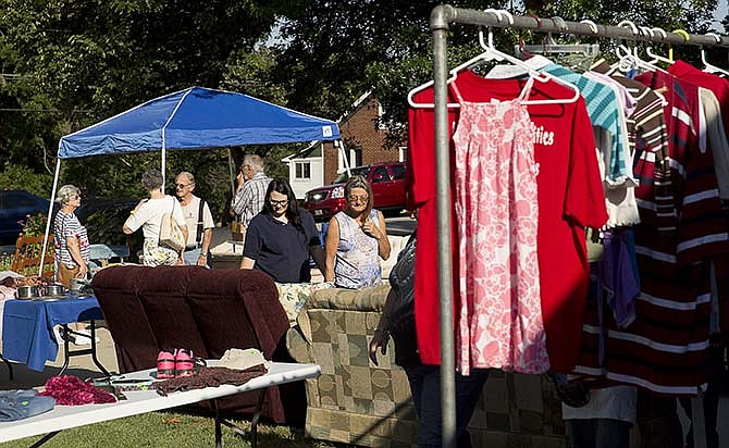 Customers browse donated items Saturday during a garage sale held in Jefferson City at the home of local veterans
advocate Pat Kerr. Proceeds from the sale will benefit three separate families or individuals
who are facing or have recently overcome homelessness.