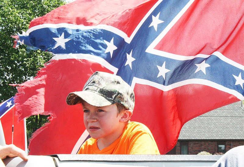 Taylor Malottki/FULTON SUN
Ozzy Renkemantle, 8, sits in the bed of a truck featuring a beaten Confederate flag prior to the flag rally Saturday. Members of the rally drove from the Fulton Walmart to the Walmart at 724 W. Stadium Blvd. in Jefferson City.