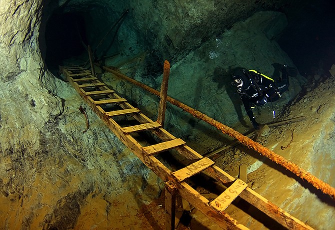 Diver Travis Marshall prepares to ascend the second of two ladders found on one of the advanced trails at Bonne Terre Mine. 