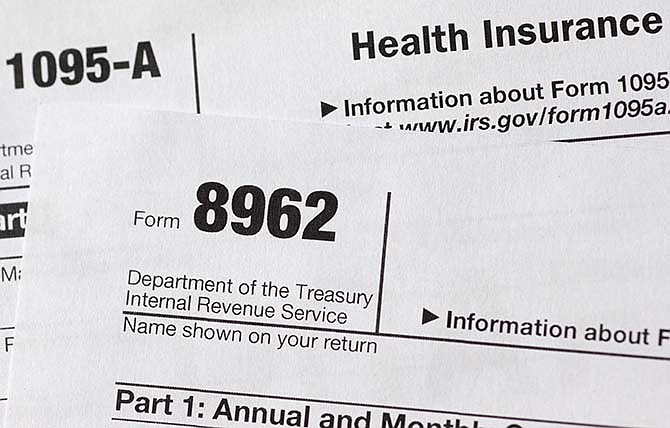 This Aug. 21, 2014, file photo, shows health care tax forms 8962 and1095-A.  About 1.8 million households that got financial help for health insurance under President Barack Obama's law have issues with their tax returns that could jeopardize their subsidies next year.