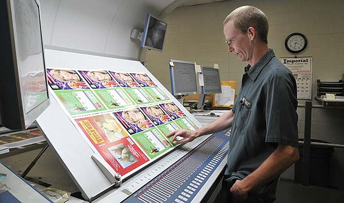 Press operator Terry Calame inspects a printed sheet off the KBA Rapida 106 sheet fed printer. Command Web is committed to growth and to that end, availed themselves a few years ago of the tax abatement program to make a major capital investment in their continued success. 