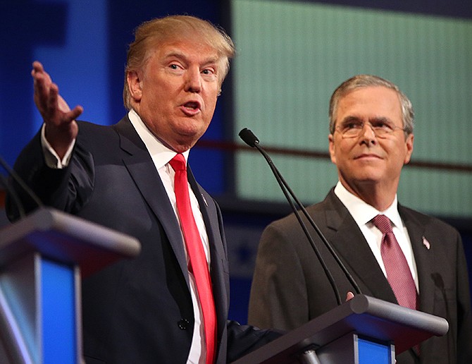 Republican presidential candidate Donald Trump speaks Thursday as Jeb Bush listens during the first Republican presidential debate at the Quicken Loans Arena in Cleveland. 